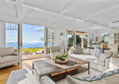 picture of living room that opens to a deck on the ocean