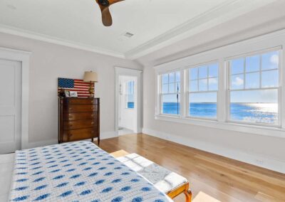 Bedroom with 3 large windows overlooking the water