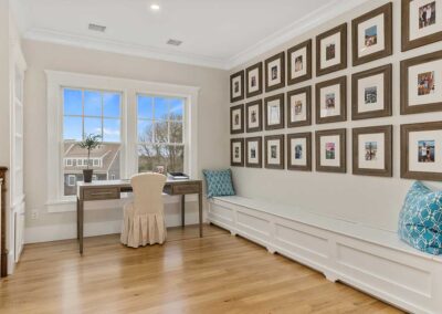 Upstairs hallway with bench and family photographs